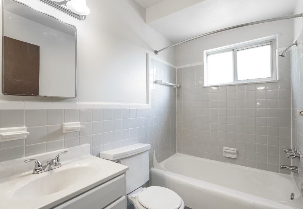 an empty bathroom with a sink toilet and bath tub